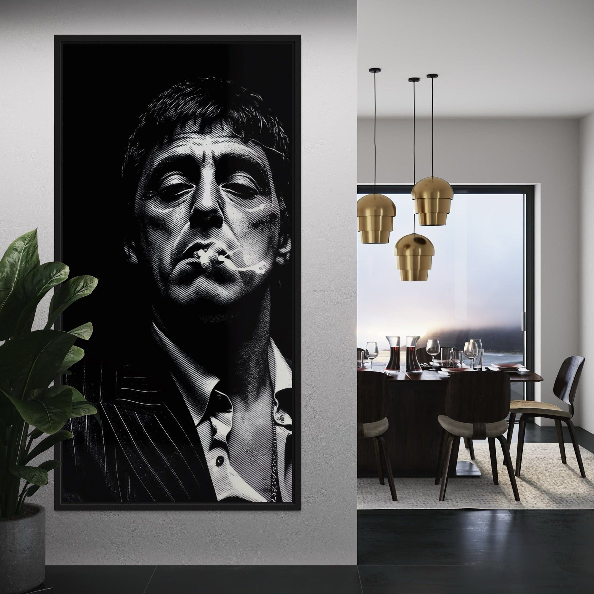 Framed black and white portrait of a man smoking in a modern dining room with gold pendant lights.
