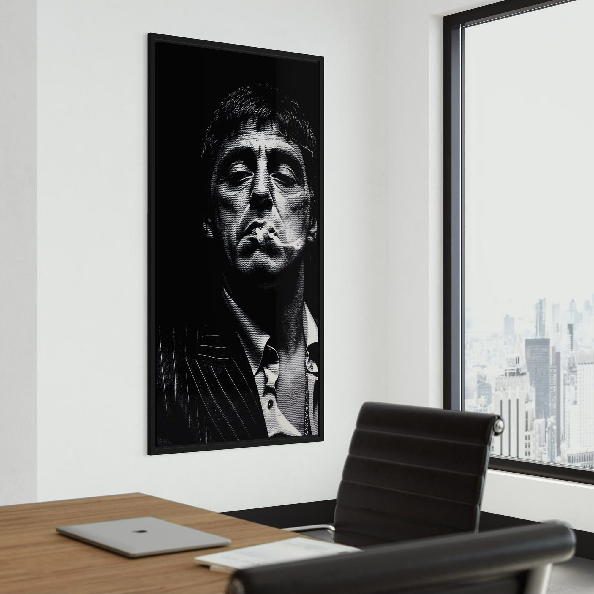 Framed black and white portrait of a famous actor on a wall above a desk with a cityscape view.