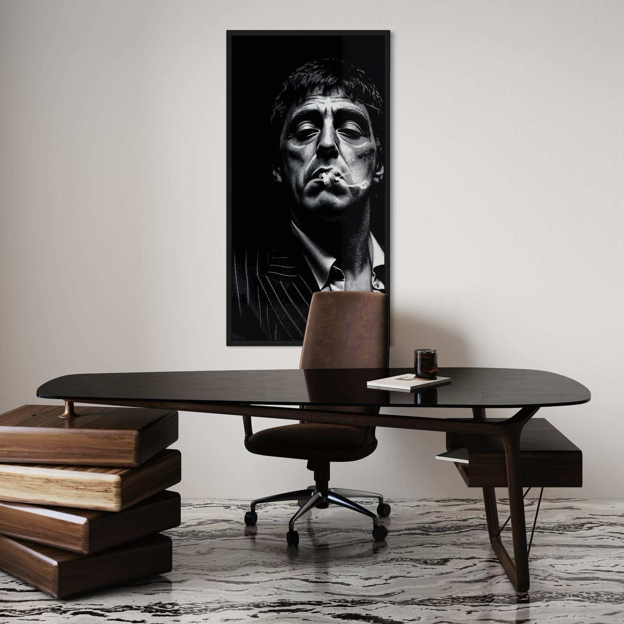 Modern office setup with a black desk, brown chair, and a framed black and white portrait on the wall.