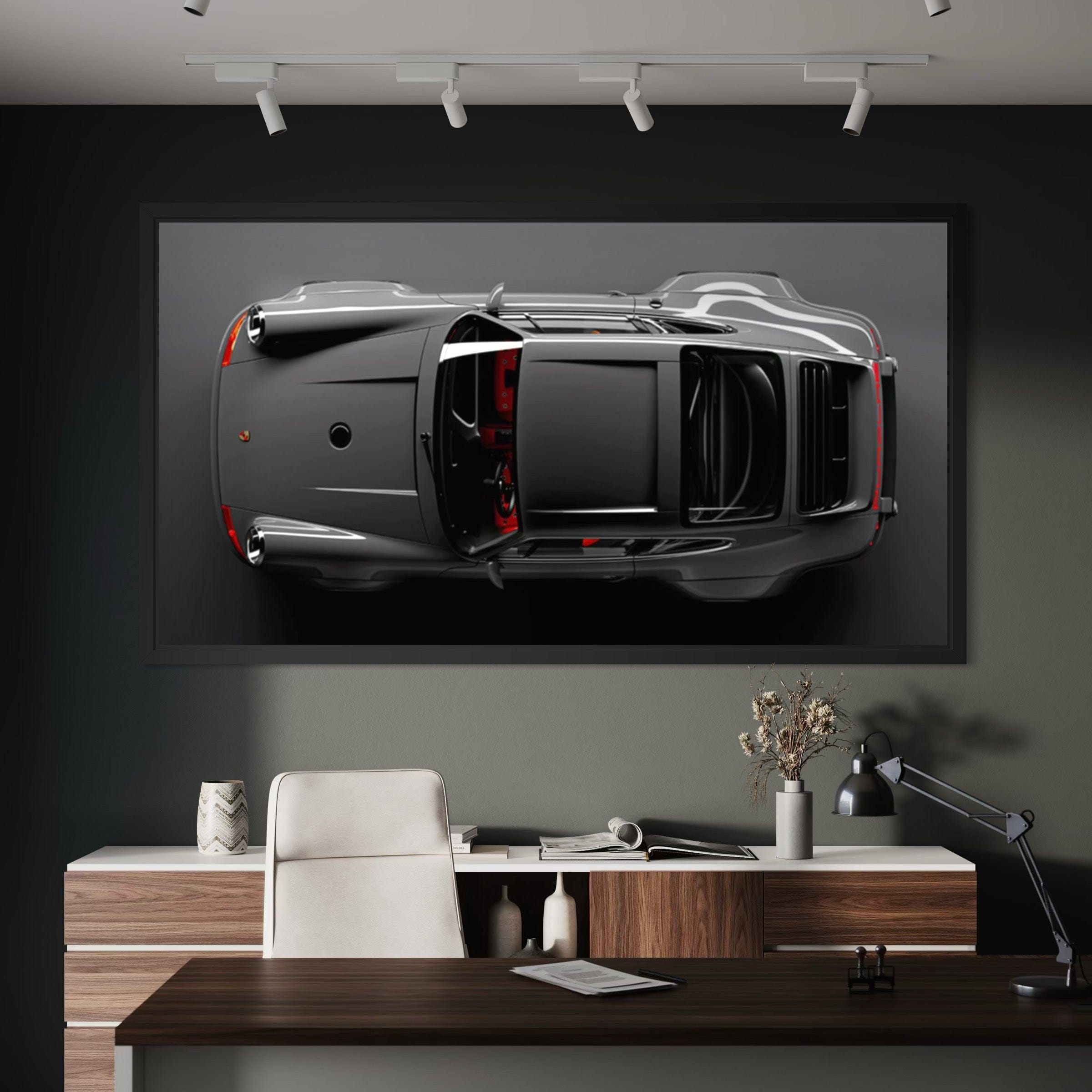 Framed artwork of a car on a wall above a desk in an office setting