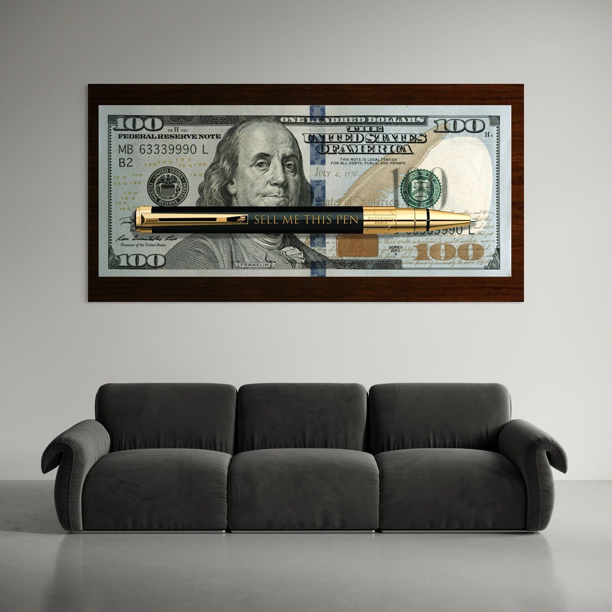 Large motivational money canvas art showing scale above modern office desk