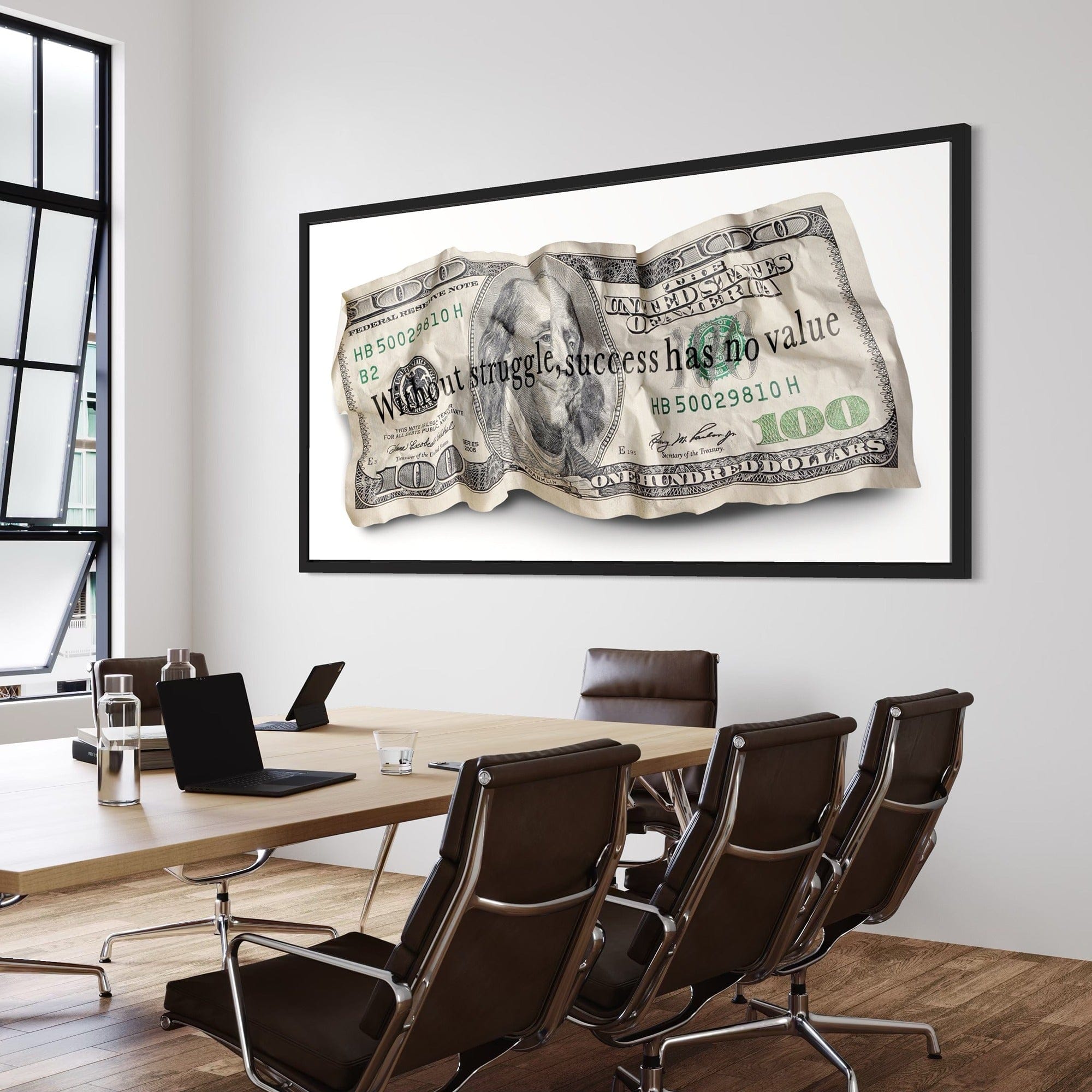 Conference room with a large framed picture of a $100 bill on the wall.