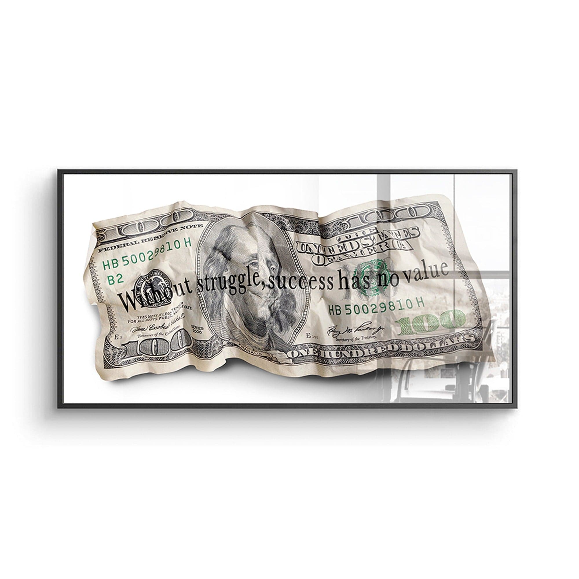 Framed dollar bill with text 'Without struggle, success has no value' on a white background