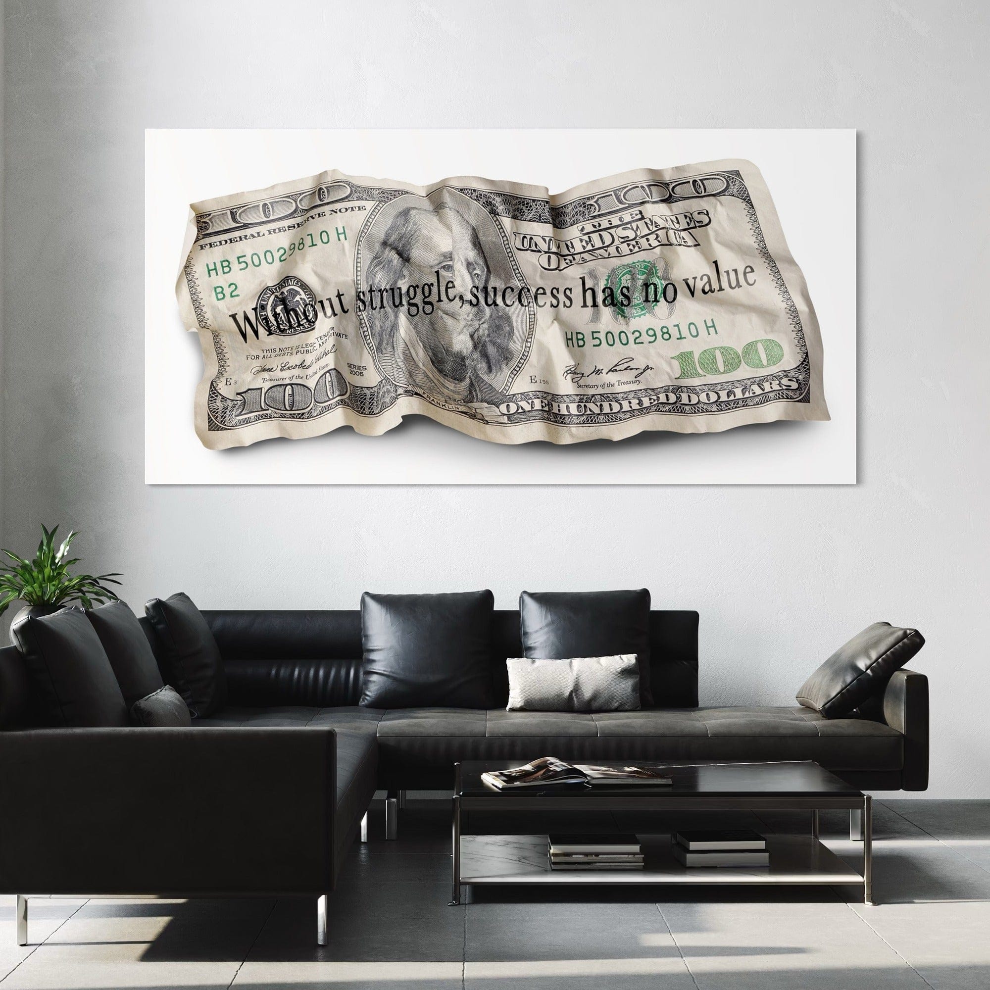 Framed artwork of a crumpled dollar bill with text in a modern living room.