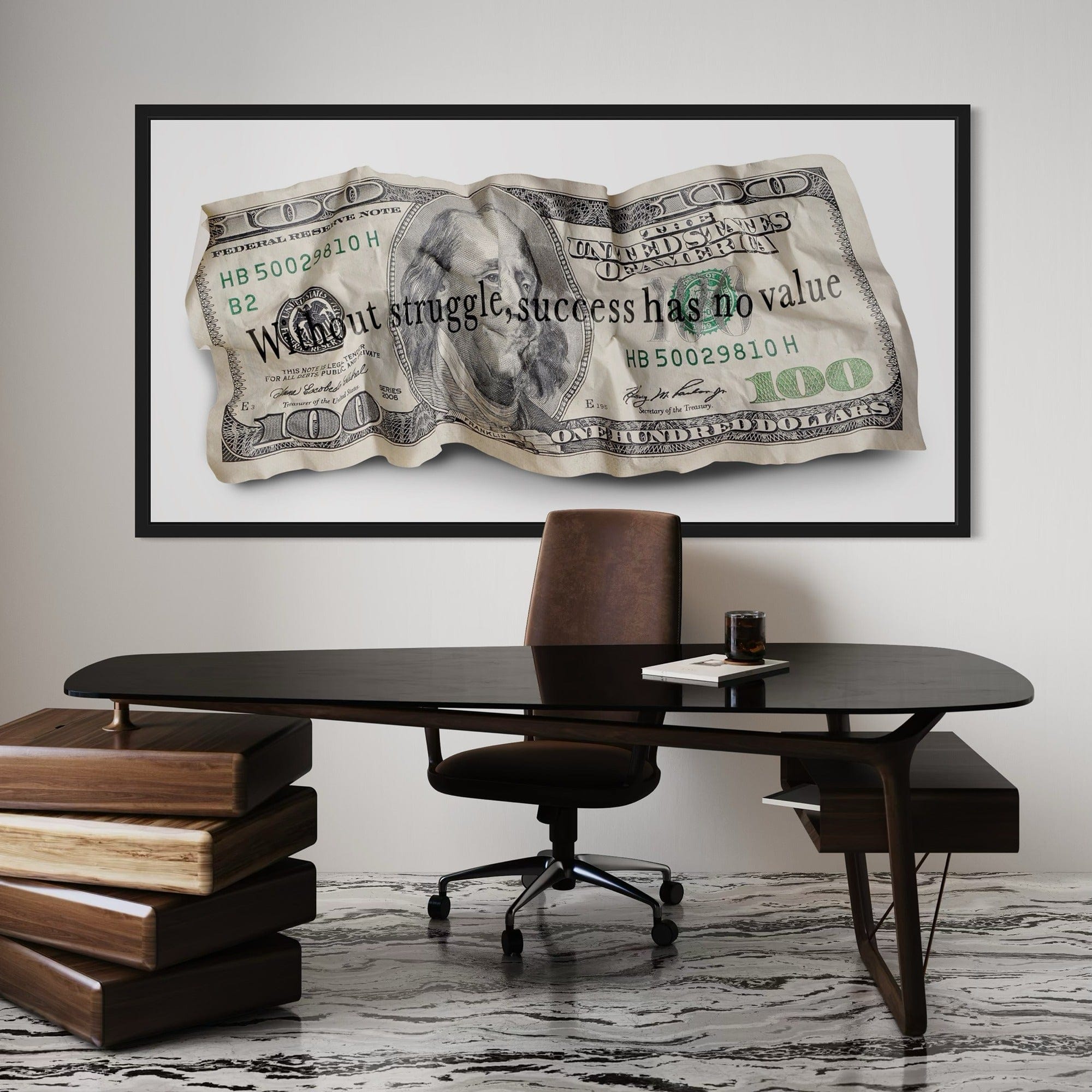Framed dollar bill artwork above a desk with a chair